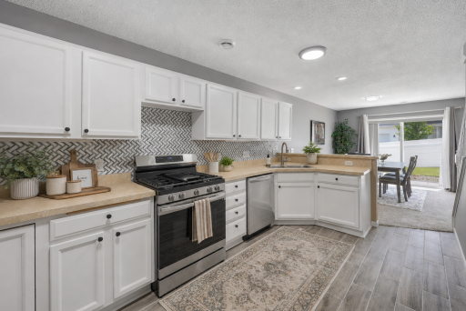 Updated Kitchen with Tile Backsplash and updated Cabinetry - some accessories virtually staged