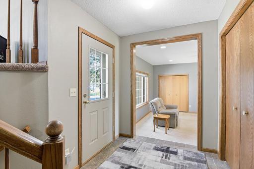 Front door with large foyer and granite tile flooring.