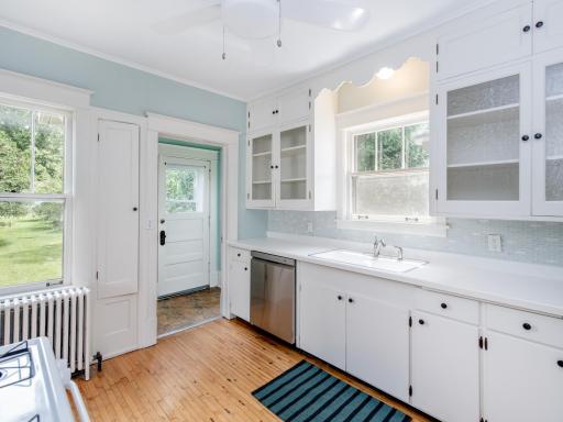 Bright, sunny kitchen with new dishwasher and loads of storage. Direct access to yard and Patio. Tiled Backsplash.