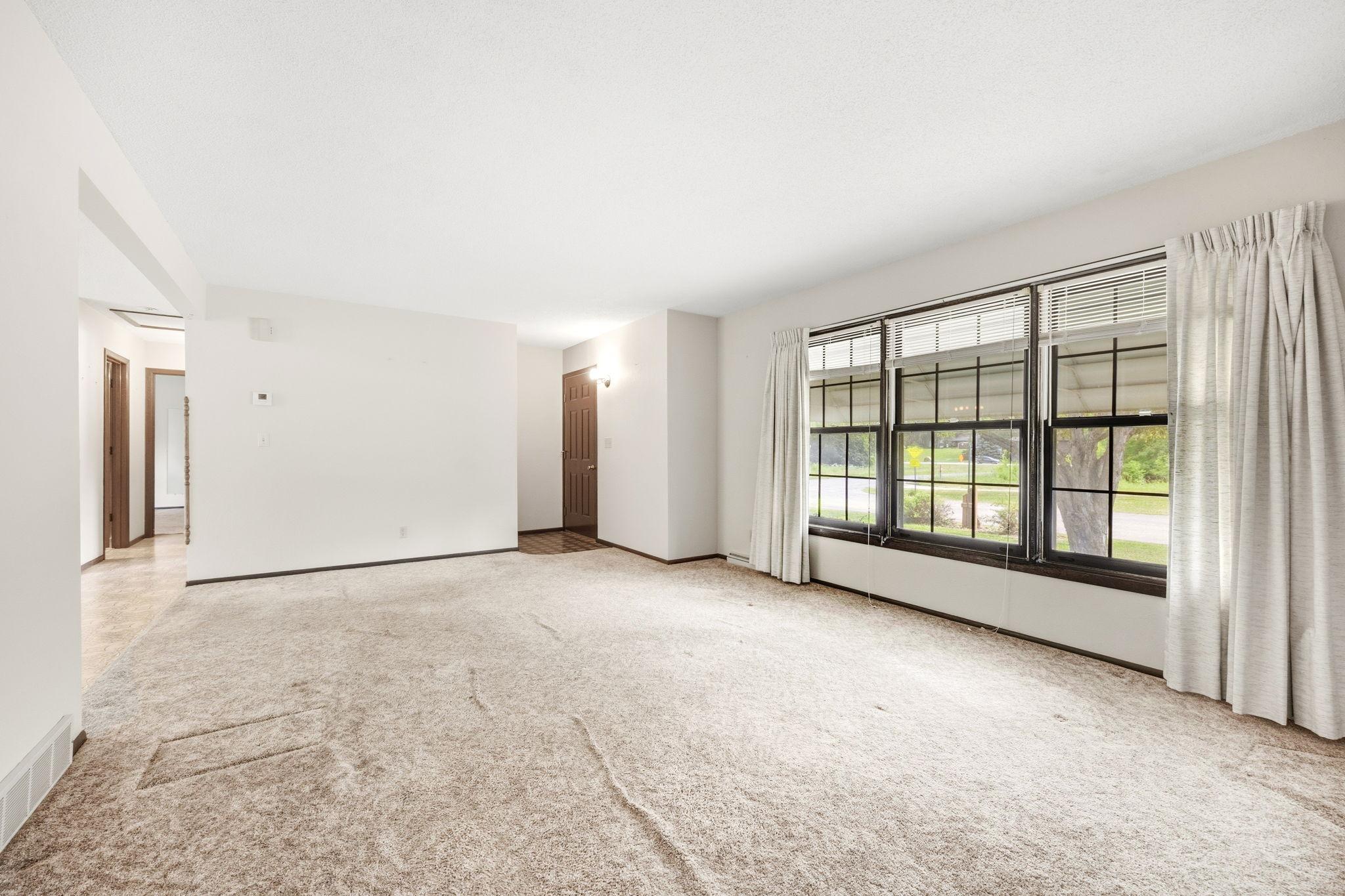Spacious living room with large windows that fill the space with natural light.