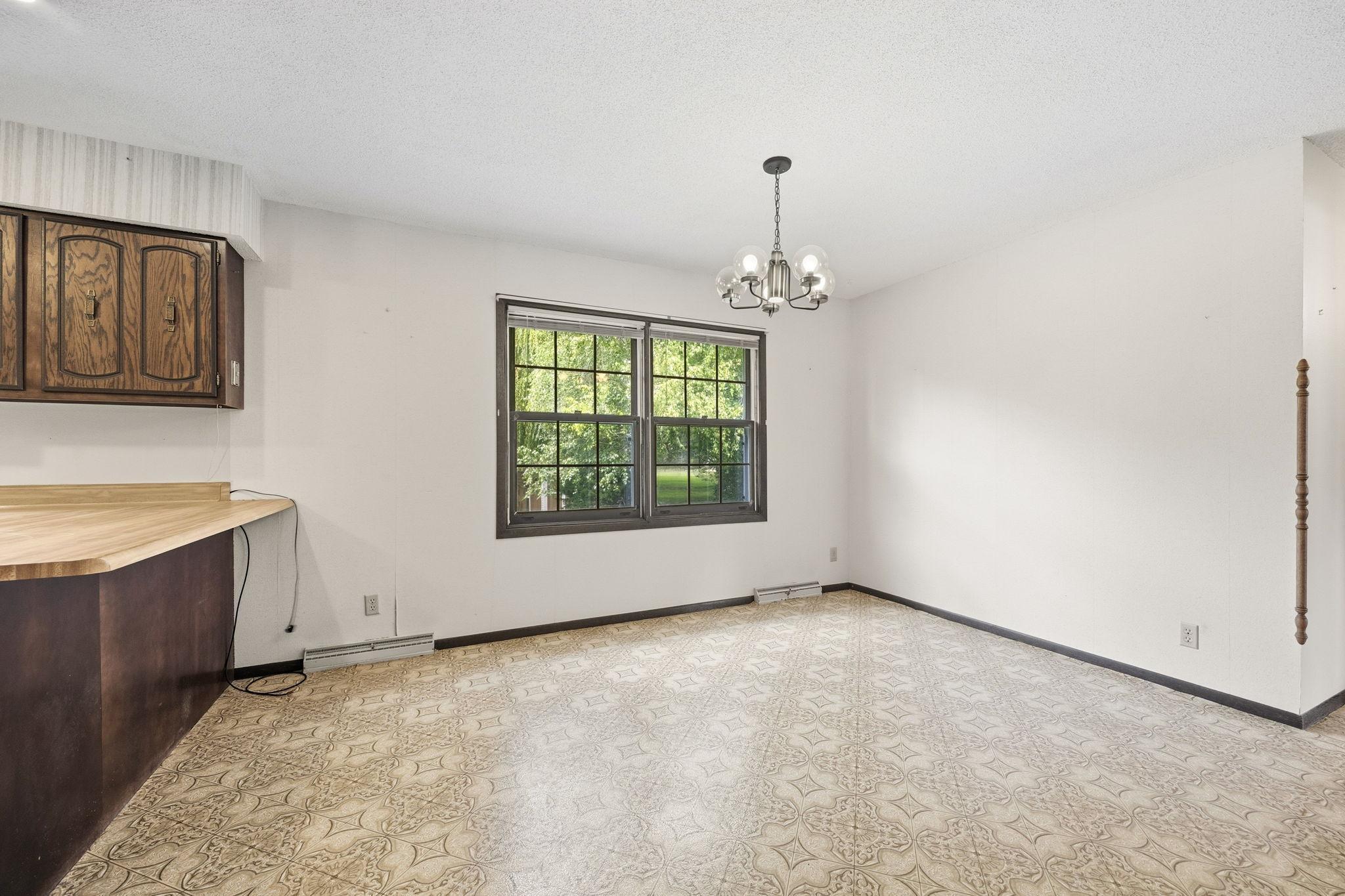 Bright dining area with large windows overlooking the backyard and plenty of space for everyday meals or entertaining.