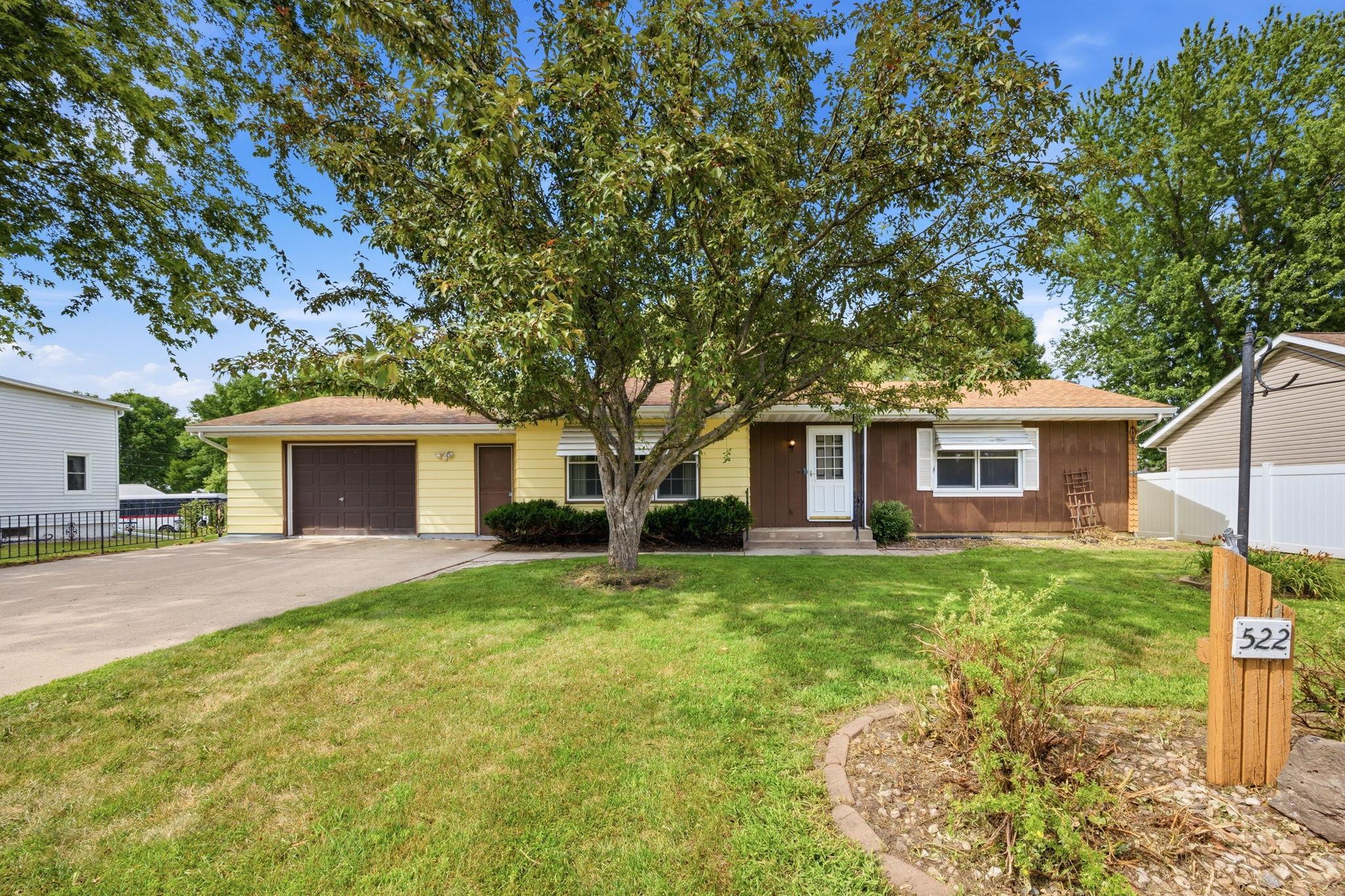 Charming rambler on a spacious lot with mature trees, an attached garage, and welcoming curb appeal.