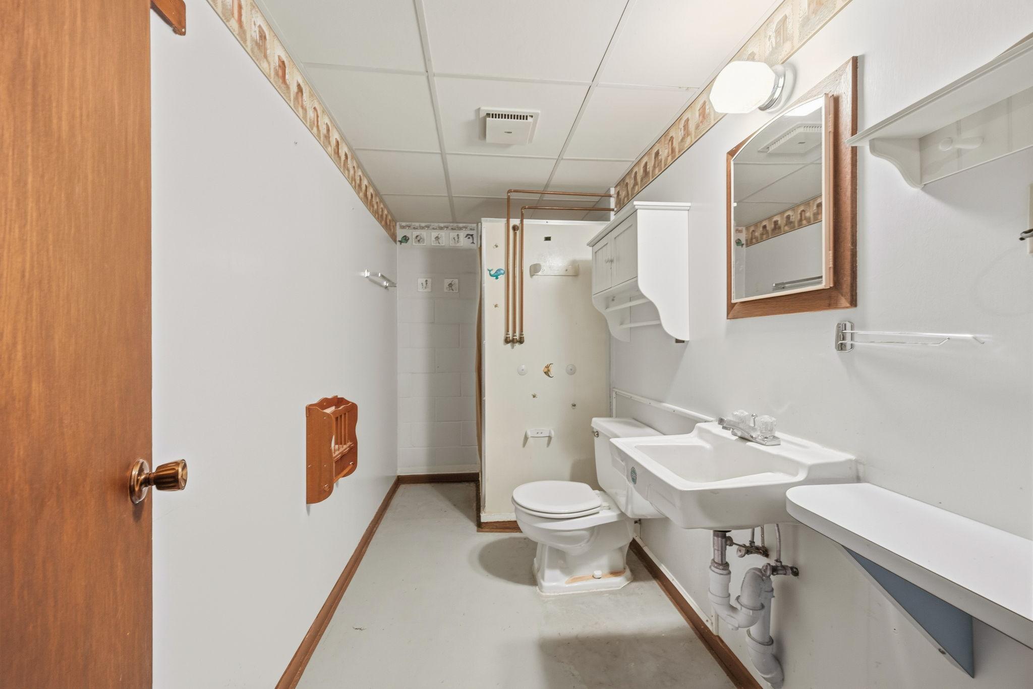 COnvenient lower-levl bathroom with shower, offering added functionality for family and guests.