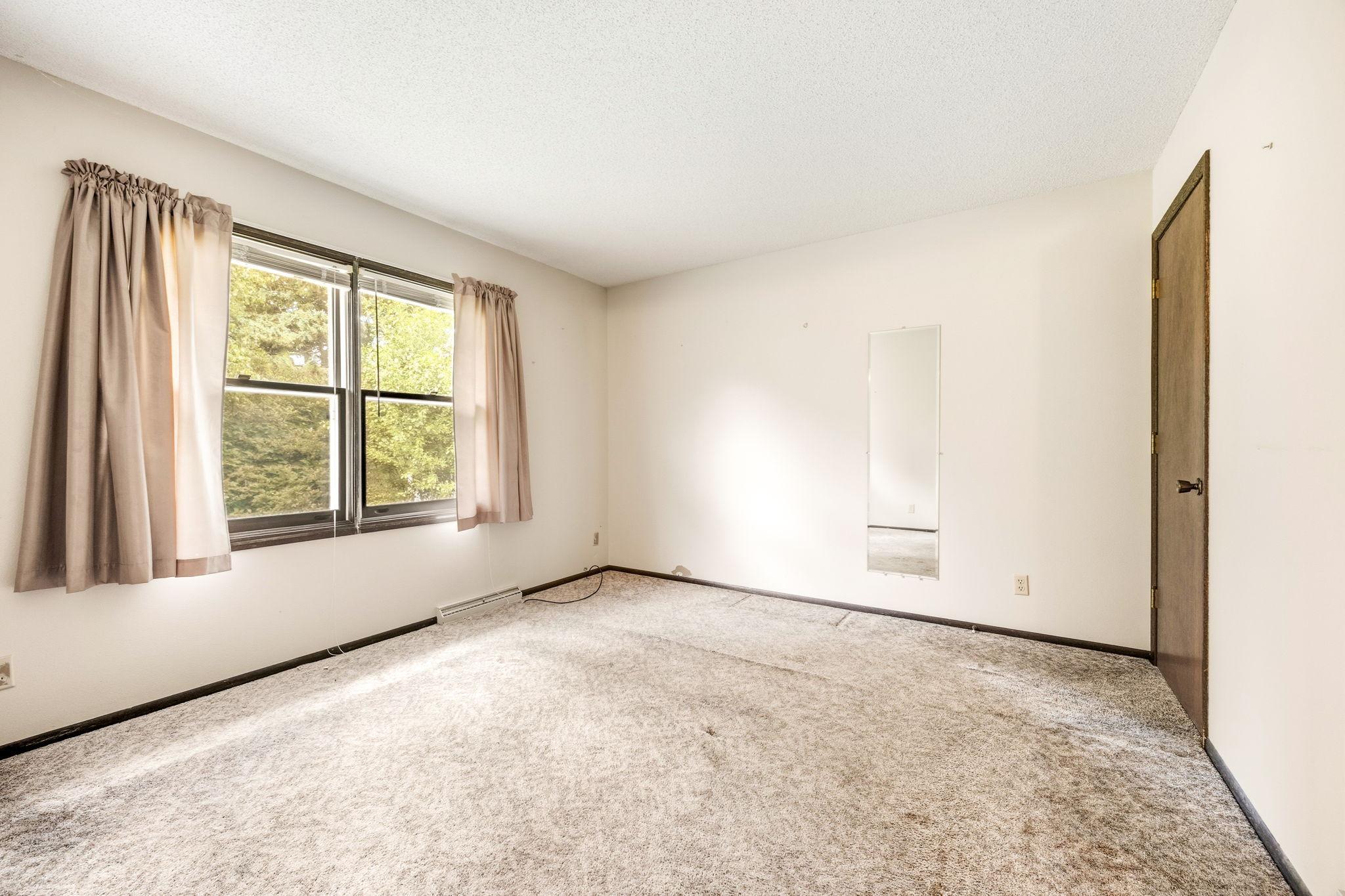 Versatile bedroom with ample natural light and closet space.