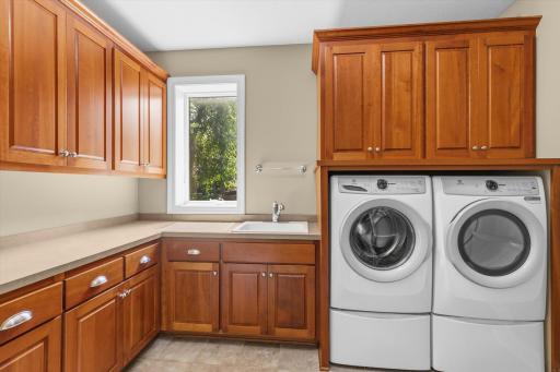 Laundry room with great cabinet space and a new washer and dryer