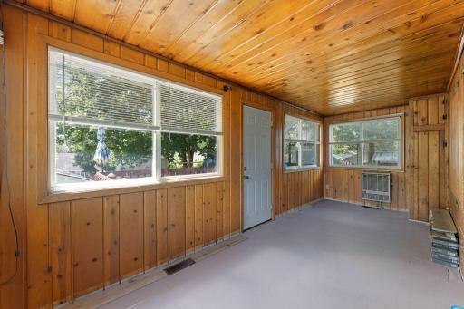 Knotty pine back porch with new flooring ready to install