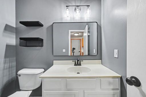 Convenient main-level half bath located near the garage entry and main living spaces..jpg