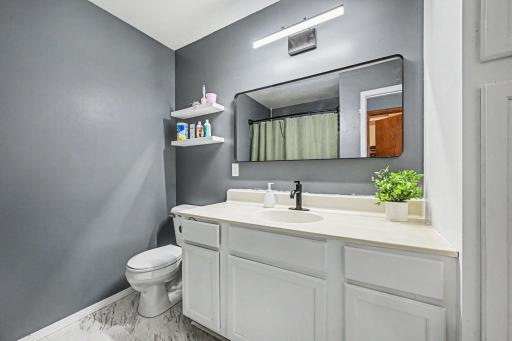 Private full bathroom connected to the primary bedroom suite with vanity storage and tub:shower combination..jpg