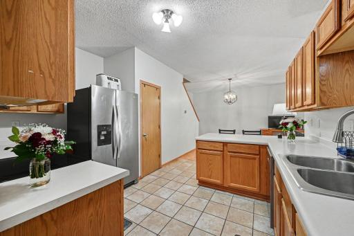 Open kitchen layout with wood cabinetry, breakfast bar peninsula, and easy access to the dining and living spaces..jpg