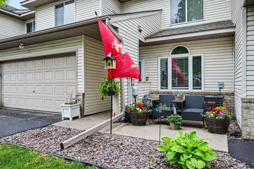 Welcoming front entry with landscaped walkway, mature plantings, and covered entry detail..jpg