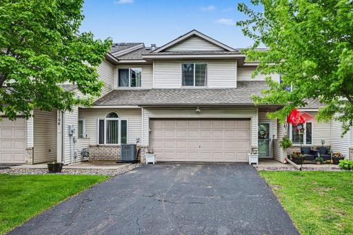 Two-story twin home in Chaska, MN featuring an attached 2-car garage and mature front yard landscaping..jpg