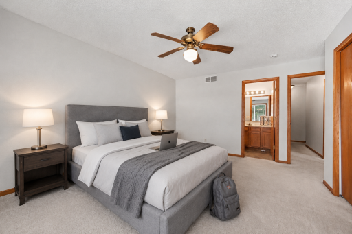 Second bedroom suite with room for a full furniture layout and direct access to its own full bathroom. (virtually staged to show potential layout).png