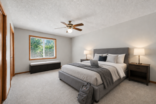 Spacious upper-level bedroom with neutral finishes, natural light, and easy access to a private full bathroom. (virtually staged to show potential layout).png