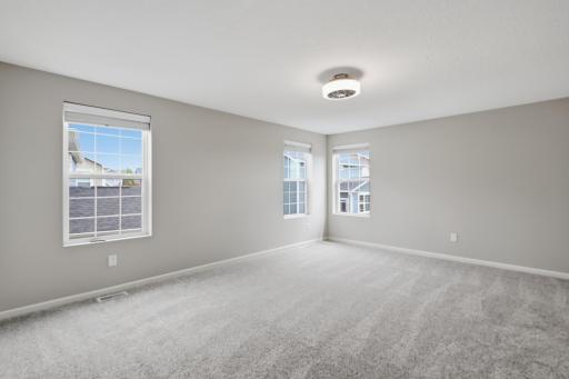 Spacious primary bedroom with room for a king-size furniture set.