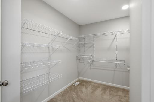 Large walk-in closet provides exceptional storage and organization.