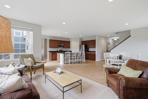 Spacious main-level living room featuring new white oak laminate flooring.
