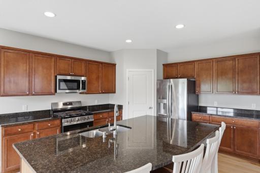 Updated kitchen featuring brand-new stainless steel range and microwave.