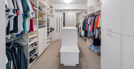 two separate extra large his and hers primary closets