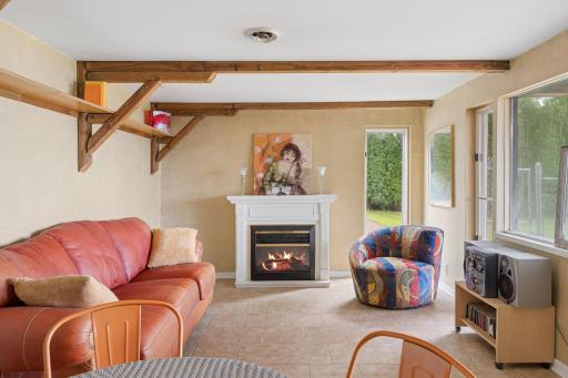Nicely tiled floors, electric fire place, and beam ceiling