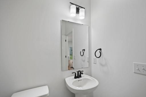A first-floor powder room is easily accessible from the communal living and dining spaces.