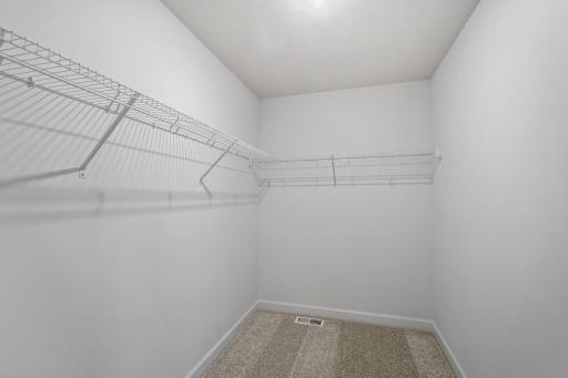 Ventilated shelving is featured in the walk-in closet