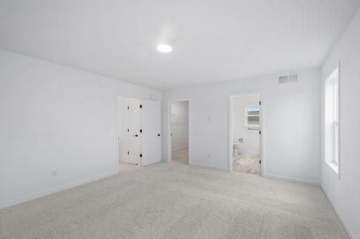 The owner's suite has direct access to a private bath and walk-in closet