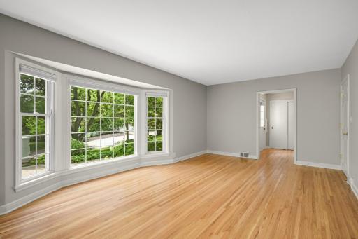 A spacious living room with a large bay window