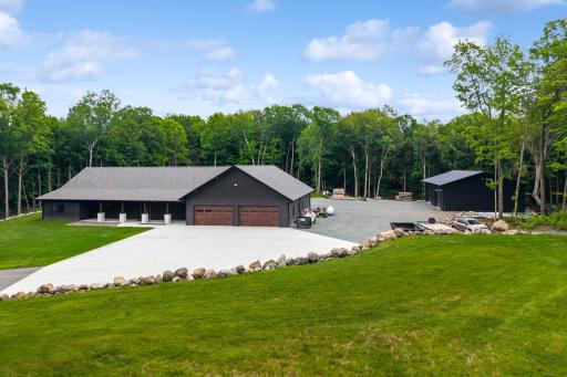 Boulder retaining walls, established trap rock and expansive concrete pad