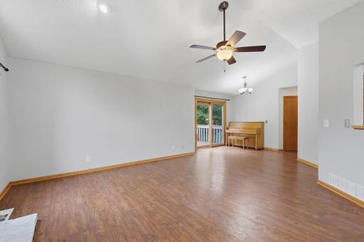 Dining space connected to living room and opens up to the deck through sliding glass door.