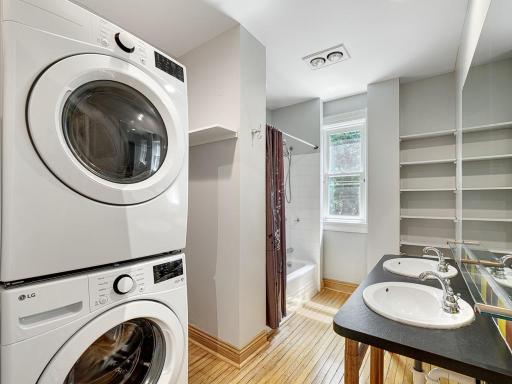 The second floor laundry shares space with the full bath