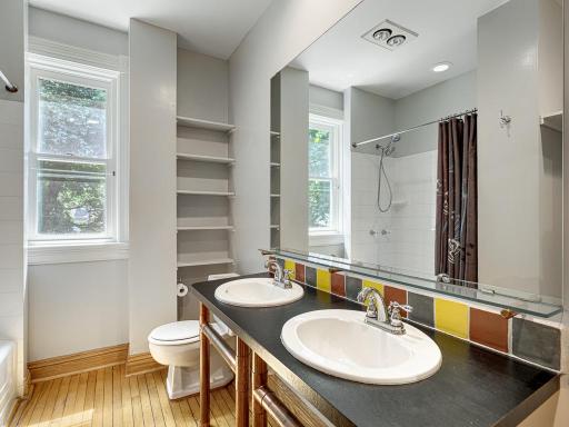 This bath has a tub/shower and duel sinks