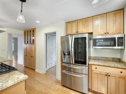 Granite counter tops, stainless steel appliances and custom cabinetry update the kitchen