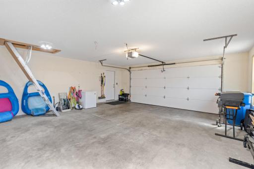 Reverse view of the finished garage showcasing a brand-new insulated steel door, and a premium belt-drive Chamberlain smart motor installed in 2025!