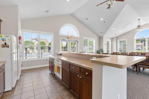 Spacious and bright community kitchen area offering extensive cabinetry storage and plenty of serving counter footprint!