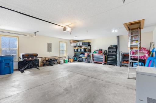 Immaculately clean, finished 2-car garage featuring a sturdy pull-down staircase that provides effortless access to an expansive and highly valuable upper storage area!