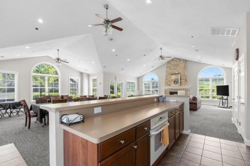 Impressive open-concept flow across the grand clubhouse community room, highlighting the massive walls of sunlit windows!