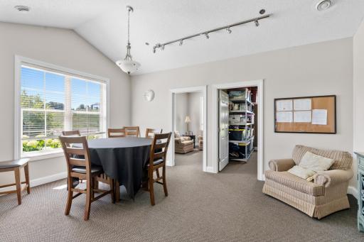 Versatile clubhouse meeting room wrapped in bright windows with scenic views! Notice the private corner library entrance, complete with comfortable seating and plenty of books to read!