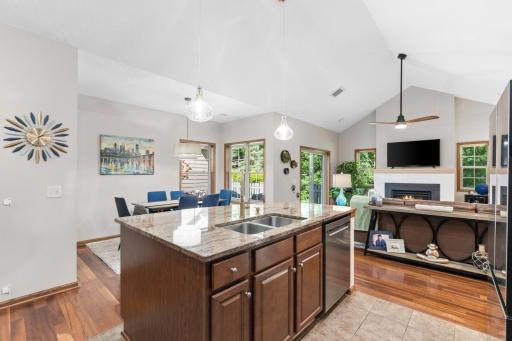 View from the kitchen island illustrating the magnificent, open-concept floor plan that connects seamlessly to the dining space and vaulted living room areas!