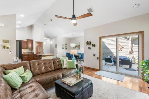 Bright living area featuring sliding glass doors to the private concrete patio, seamless flow into the kitchen, and newly updated, clean HVAC ceiling registers throughout!