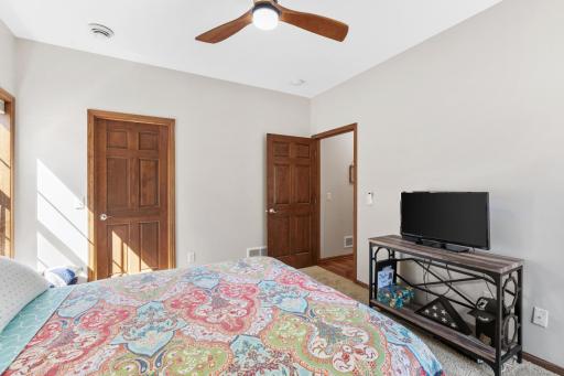 Reverse view of the bright bedroom 2, illustrating the convenient walk-in closet storage, crisp trim work, and pristine condition of the turn-key interior walls!