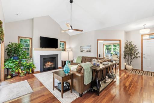 This stunning open-concept living room layout includes soaring vaulted ceilings, all-new contemporary wall paint, a modern quiet-motor ceiling fan, flawless knockdown texture, and a newly updated geometric fireplace surround, with brand-new mantel!