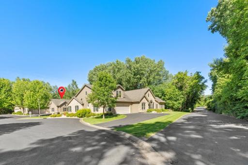 Ground-level view highlighting the private gated rear access lane! Enjoy a quick escape out the back of the community via a remote-controlled gate, saving you from driving all the way through the neighborhood to exit!