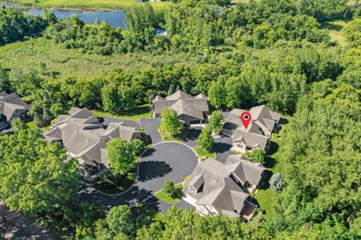 Superb aerial view illustrating the ultimate end-of-the-line privacy of this elite cul de sac setting, perfectly encased by mature woods with zero neighborhood traffic driving past your door!