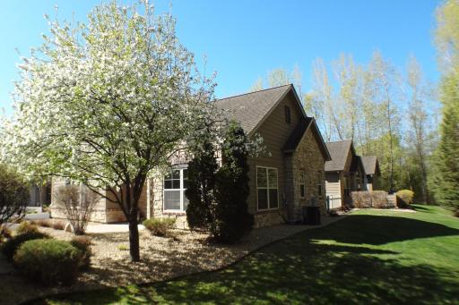 Gorgeous springtime perspective highlighting the blossoming apple tree near the front entry, framing a peaceful look across the open, manicured yard space!