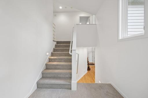 Stairs to upper level to additional two bedrooms