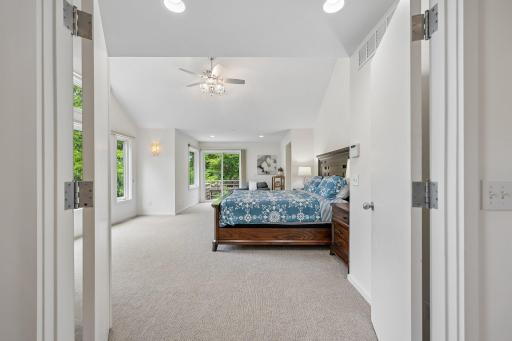 Primary bedroom with vaulted ceilings and tons of natural lighting