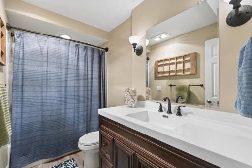 View of the lower-level full bathroom. This home is ready for its new owners to enjoy with number of mechanical and exterior updates done in recent years including the water heater, carpeting, roof, garage doors, kitchen appliances and skylights.
