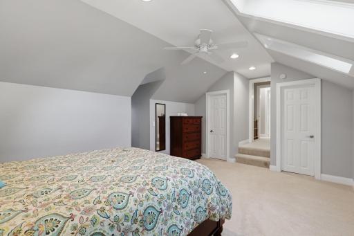 View of the second of four bedrooms on the upper level of the home. This with plenty of storage. Skylights were replaced in 2022.