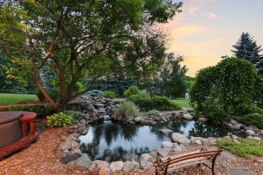 View of the tranquil pond with the perfect spot for a hot tub for the ultimate relaxation. The pond is plumbed into the irrigation system that has its own well to bring fresh water into the pond to keep things clear and clean.