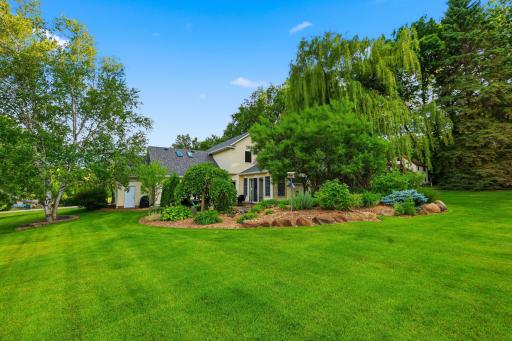 View of the expansive back yard that is flat and usable space and everything here can be mowed with a riding lawn mower for easy maintenance.